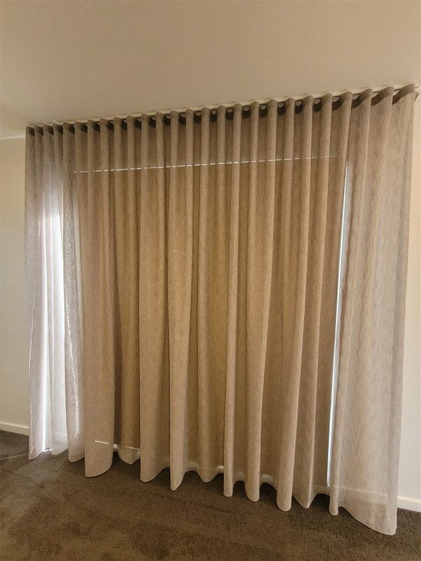 Floor-length blockout curtains in a bedroom