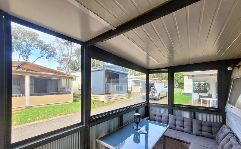 Clear PVC cafe blinds enclosing a holiday-park annex in Cowes