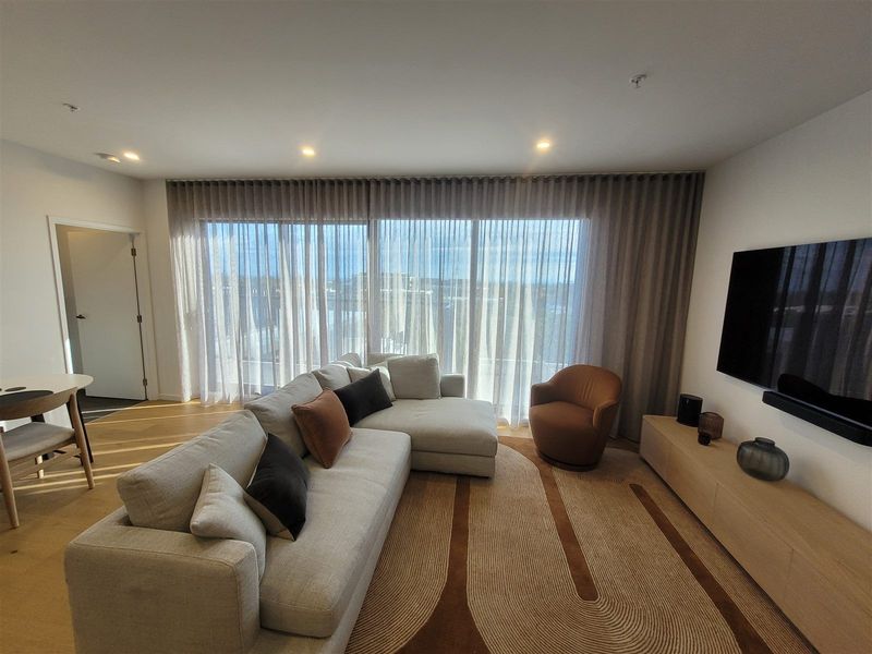 Sheer curtains across a wide living room window