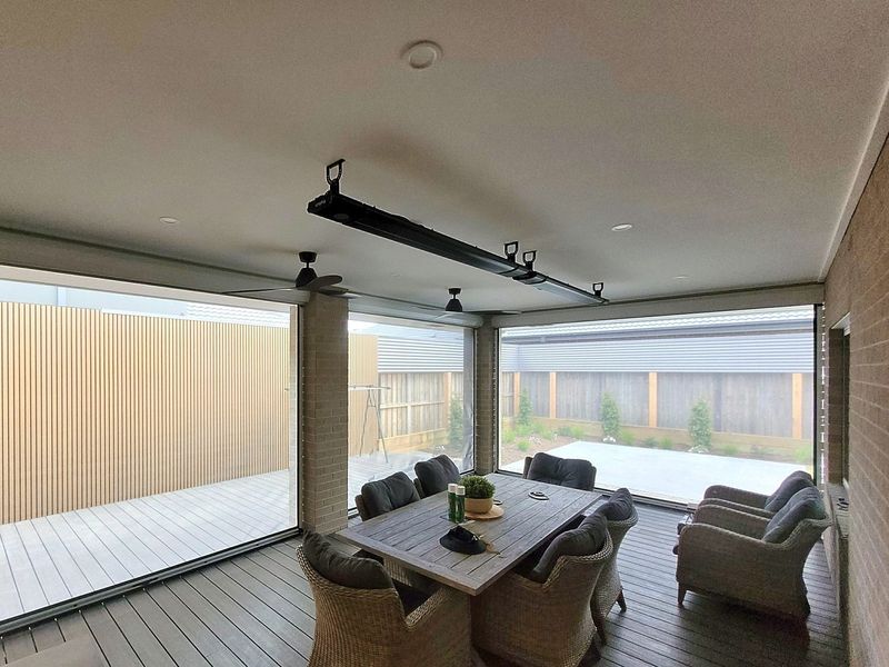 Enclosed alfresco with zip track blinds, outdoor dining table and timber deck in Botanic Ridge